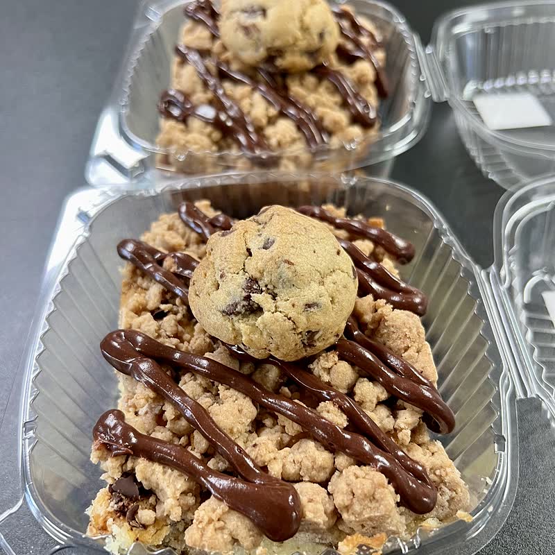 A gluten-free chocolate chip cookie crumb bar under a chocolate drizzle
