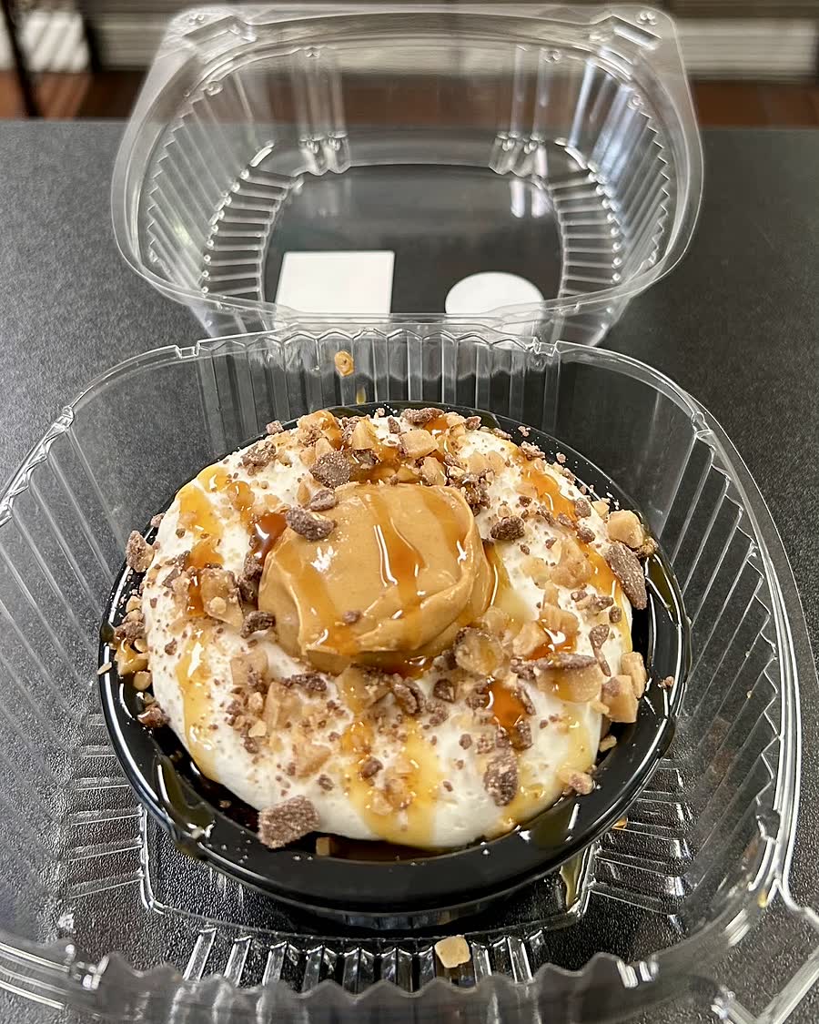 A gluten-free mini cream pie topped with peanut butter, caramel and toffee pieces