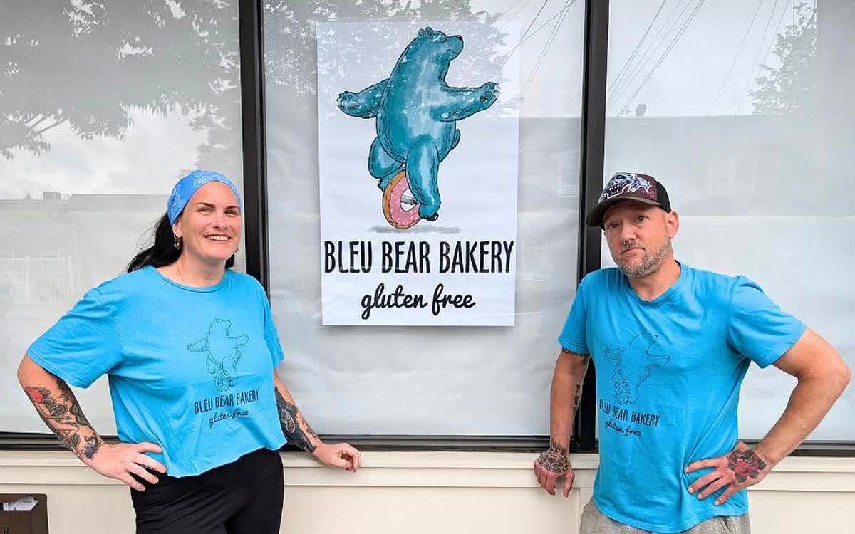 Ridgway Grace and Dan Schlueter outside Bleu Bear Bakery, either side of the shop&rsquo;s bear logo
